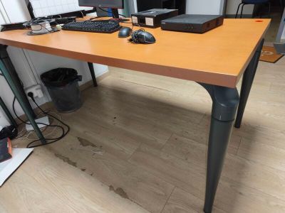 a wooden desk with a computer on top of it