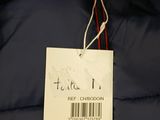 a close up of a blue jacket with a tag on it