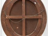 a wooden circular object on display in a glass case
