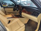 beige interior of a car with leather seats and steering controls