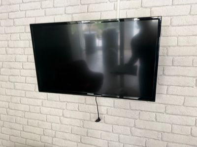 a flat screen tv mounted on the wall in the living room