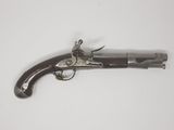 an old gun on a white surface