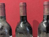 three bottles of wine that are sitting on a table