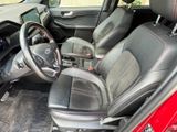 the interior of a red car with black leather seats and a steering wheel