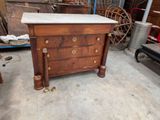 a marble top chest of drawers in a garage