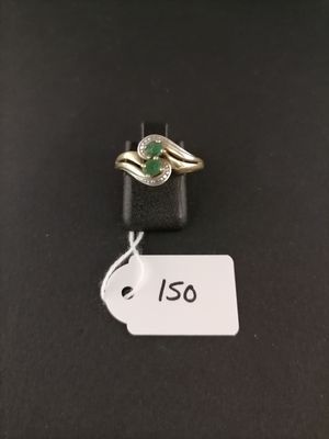 a close up of a ring on a black surface with a price tag