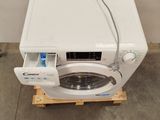 a white washing machine sitting on a pallet in a room