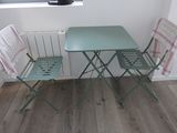 two chairs and a table in the corner of a room