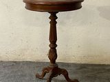 a small wooden table with a bowl on top of it