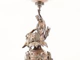 an antique silver plate with a woman and a goat on it