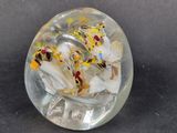 a clear glass object with yellow and white flowers inside of it