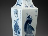 a blue and white vase with a picture of a woman on it