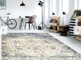 un grand tapis dans une pièce où se trouve un vélo posé par terre
