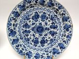 blue and white plate with blue flowers on it