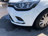 the front end of a white car parked in a parking lot