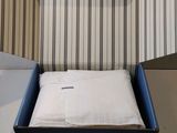 a box with a pillow inside of it on a table