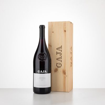 a bottle of wine sitting next to a wooden box