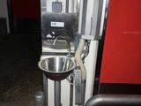 a metal sink in the corner of a room
