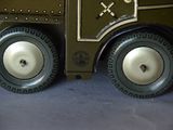 a close up of a toy army vehicle on a blue surface