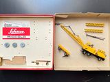 a box with a toy crane in it on a table