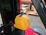 a forklift with a yellow helmet on the back of it