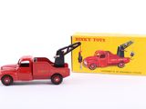 a red toy truck with a crane on the back of it
