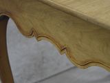 a close up of a wooden table with a drawer on it