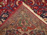 a close up of a rug with a red background