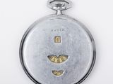 a silver pocket watch with a heart on it