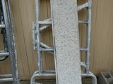 a concrete block sitting on top of a metal cart
