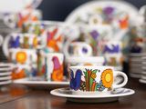 many cups and saucers sitting on a table