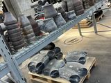many different types of pipes on the shelves in the warehouse