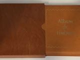 un album de l'époque ; un livre est ouvert sur une page blanche