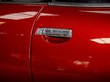 a close up of a red car door handle