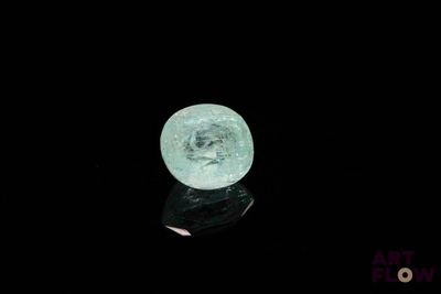 an image of a green crystal ball on a black surface
