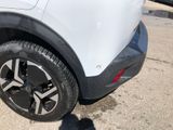 a close up of a tire on a white car