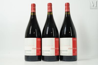three bottles of red wine sitting next to each other on a table