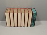 four books stacked on top of each other on a table