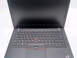 the laptop is open on a white surface with a black keyboard