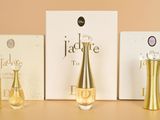 three bottles of perfume sitting next to each other on a table