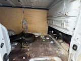 a white van that has been vandalized and is in the process of being repaired