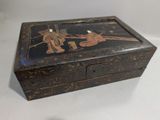 a small wooden box that has a painting on it