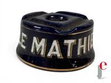 a black and gold tin with the word le mathe on it