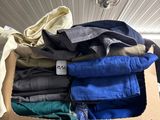 a box full of clothes that is on a shelf