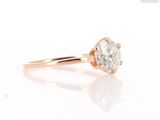 a close up of a diamond ring on a white surface