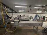 a machine that is working in a factory with a conveyor belt