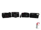 four cameras are lined up in a row on a white surface