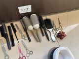 many different types of hair brushes and combs laid out on the floor
