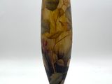 un vase avec un tableau posé sur une table