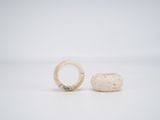 two white stone rings sitting next to each other on a white surface